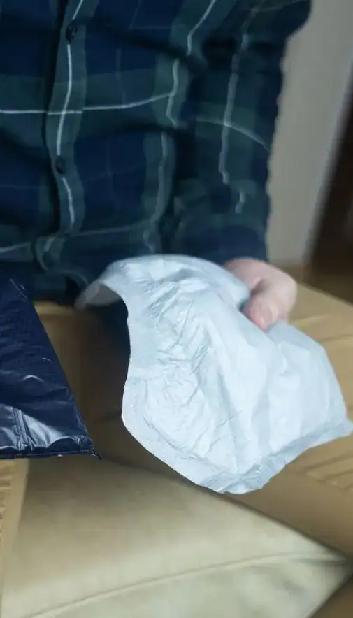 Image of man holding incontinence pads as part of overactive bladder treatment Lancaster