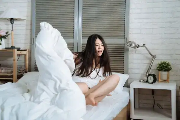 Image of woman getting up because of nighttime leaks Lancaster